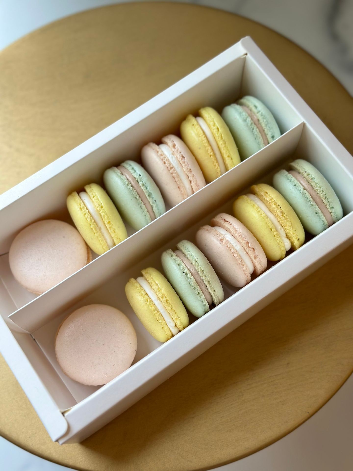 Pastel French macarons in a white gift box Pastel French macarons in a white gift box